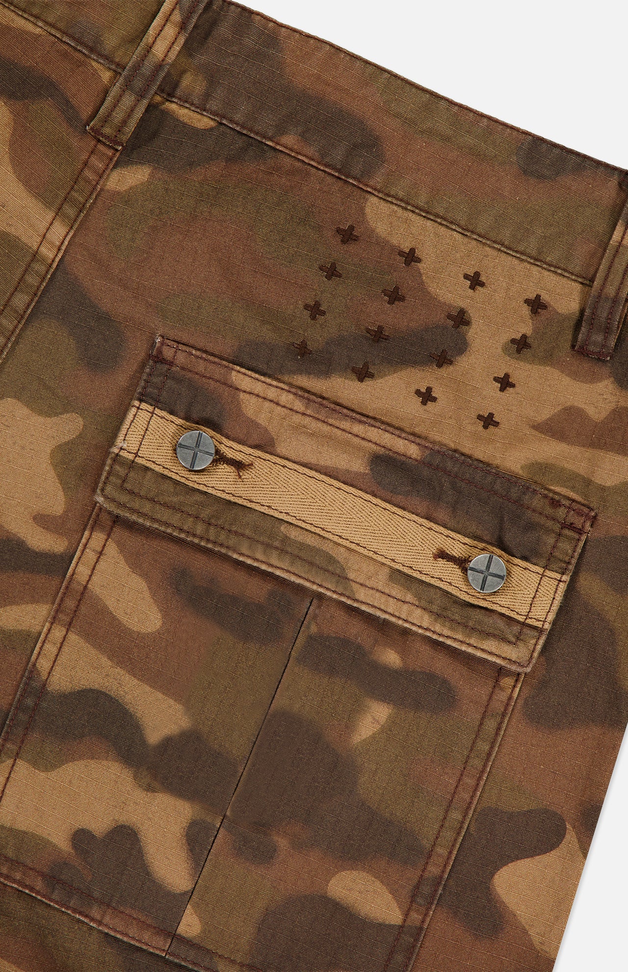 Featuring a cargo pocket with metal buttons and a row of small embroidered crosses above, the KSUBI Troop Camouflage Cargo Pant is crafted from durable cotton twill in brown and olive tones—perfect for upgrading your favorite camo look.