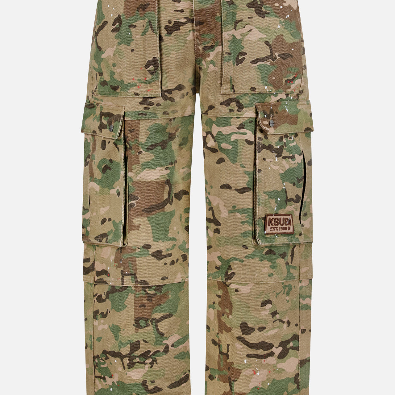 The KSUBI Trooper Camouflage Cargo Pant features a green and brown woodland camo, relaxed leg, multiple pockets including large zippered sides, metal D-rings, and a KSUBI logo patch on the right pocket.
