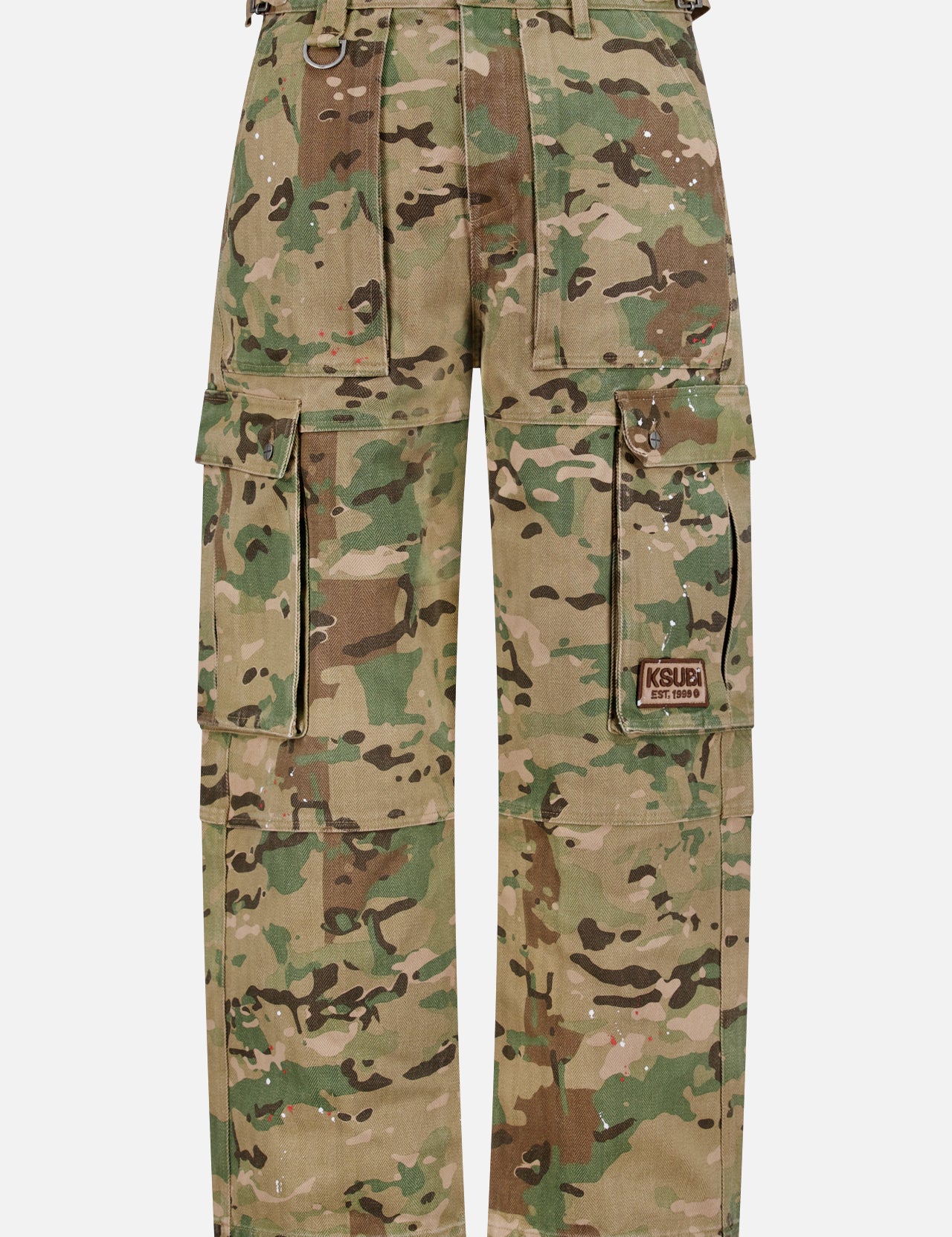 The KSUBI Trooper Camouflage Cargo Pant features a green and brown woodland camo, relaxed leg, multiple pockets including large zippered sides, metal D-rings, and a KSUBI logo patch on the right pocket.
