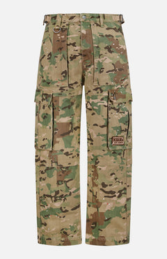 The KSUBI Trooper Camouflage Cargo Pant features a green and brown woodland camo, relaxed leg, multiple pockets including large zippered sides, metal D-rings, and a KSUBI logo patch on the right pocket.