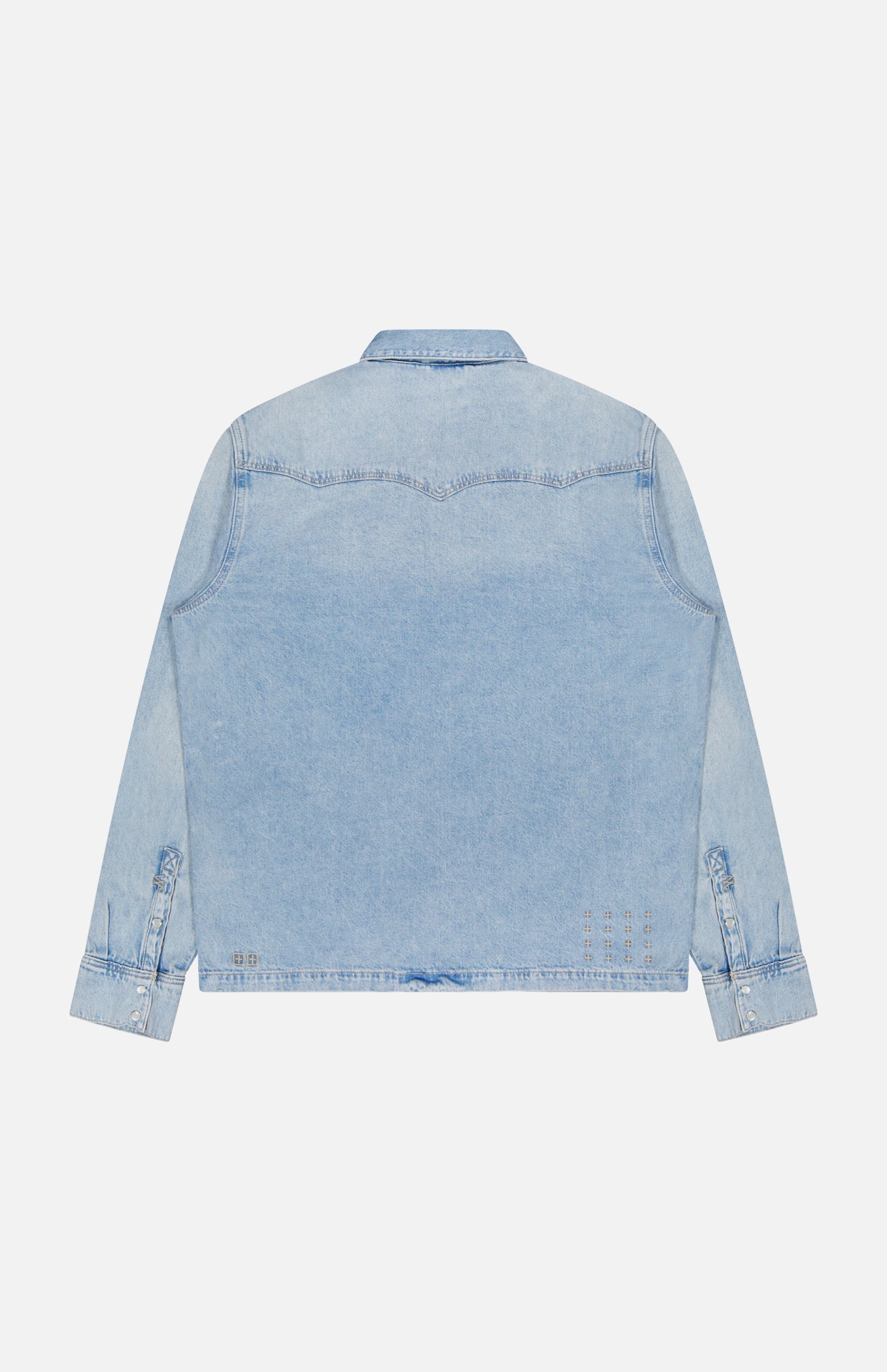 The KSUBI Whiplash Long Sleeve Western Shirt is shown from the back in light blue denim, featuring long sleeves, buttoned cuffs, and classic western-inspired yoke detailing. It has a straight hem and a slightly faded, worn-in look.