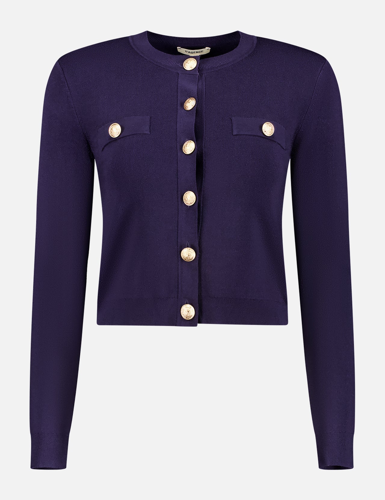 The Toulouse Cropped Crew Neck Cardigan by L'AGENCE is a deep purple, lightweight knit with long sleeves, gold front buttons, and decorative chest pocket flaps, shown against a white background.