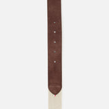A close-up of the Antibes Hybrid Smart Belt by LA BOUCLE, featuring a brown suede leather tip with adjustment holes on a beige woven fabric strap.
