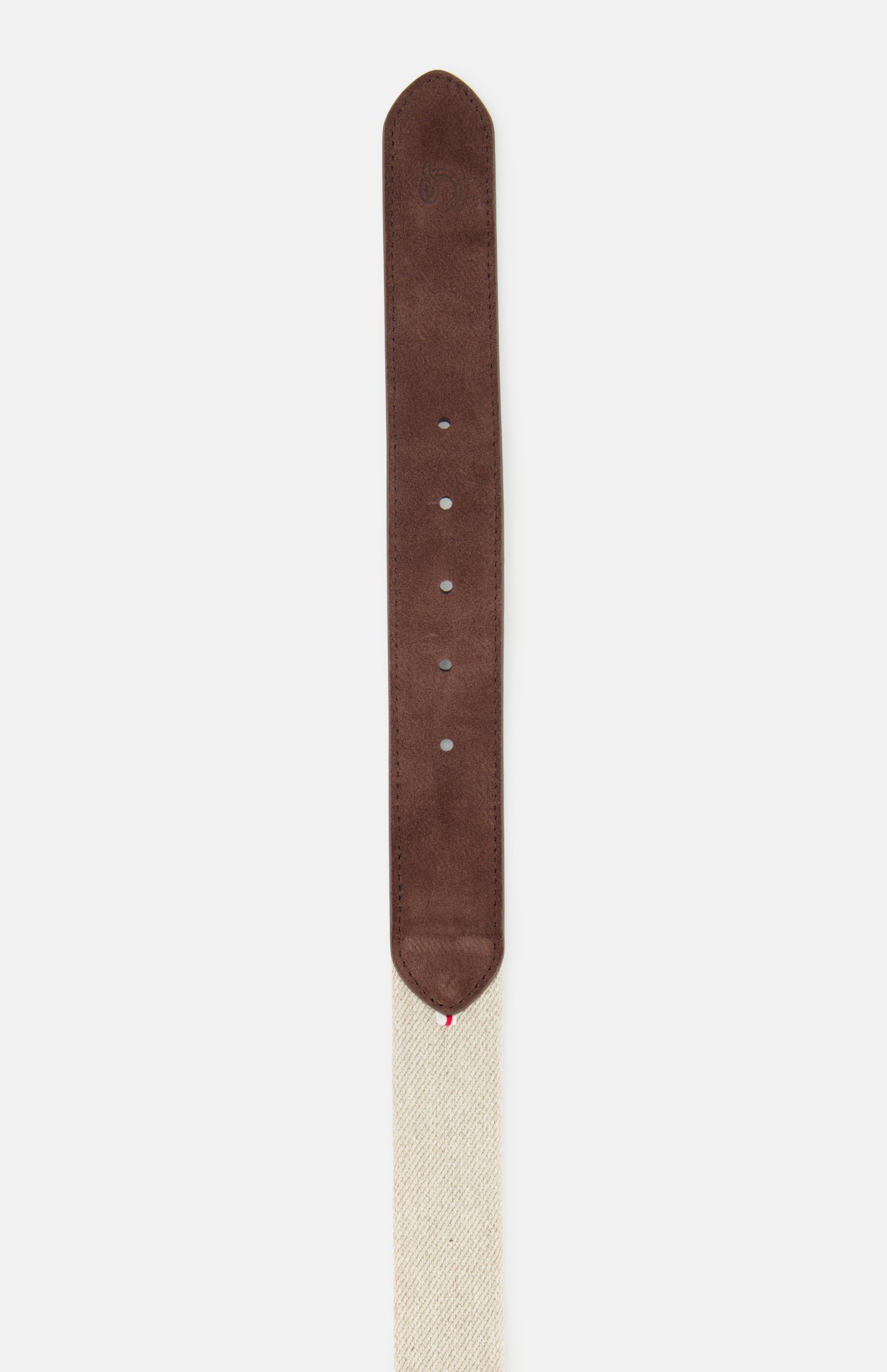 A close-up of the Antibes Hybrid Smart Belt by LA BOUCLE, featuring a brown suede leather tip with adjustment holes on a beige woven fabric strap.