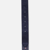 A close-up of the LA BOUCLE Palm Beach Hybrid Smart Belt in navy blue, featuring stretch fabric, a pointed tip, multiple adjustment holes, and a small red, white, and blue stitched detail near the end.