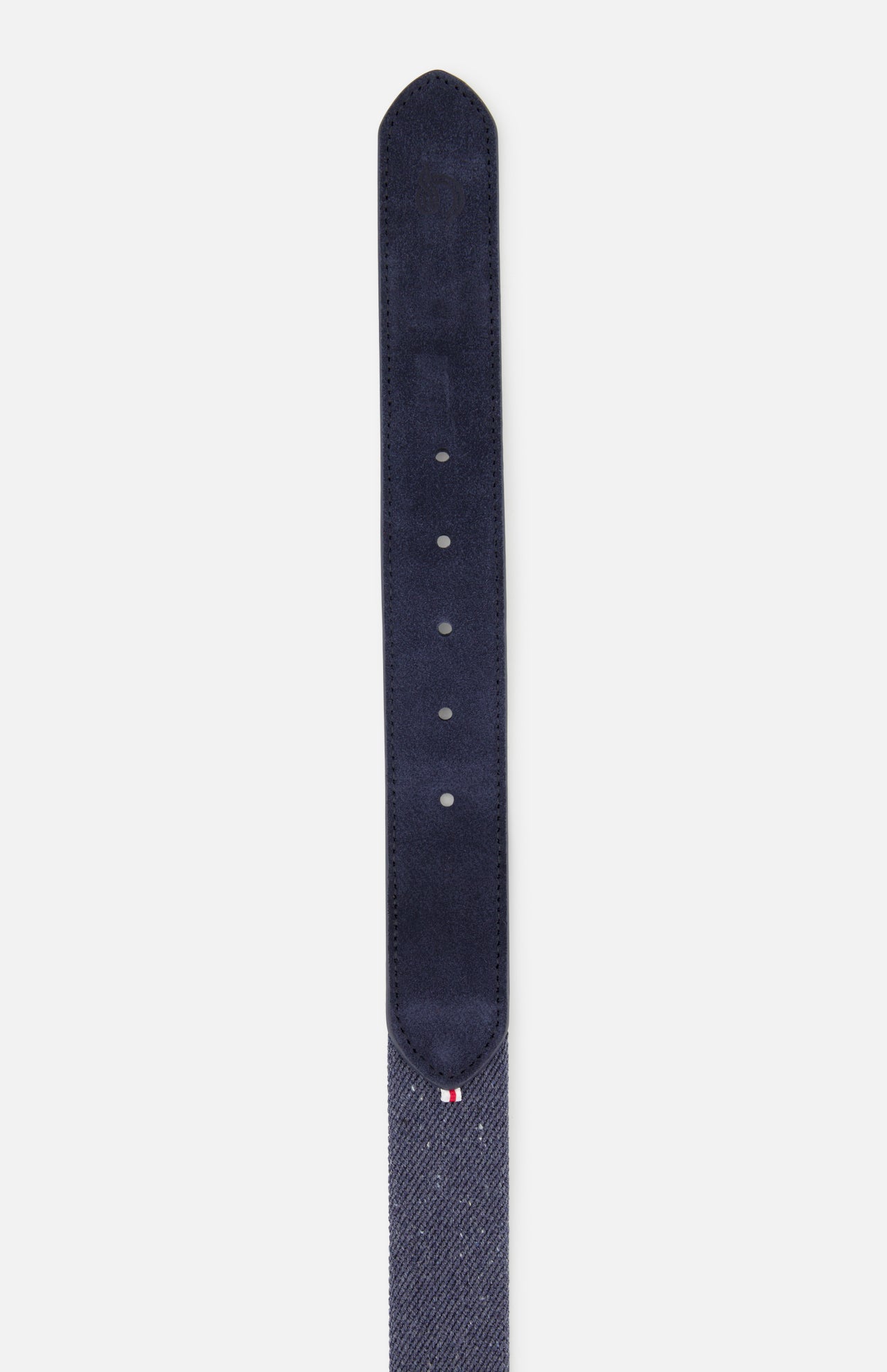 A close-up of the LA BOUCLE Palm Beach Hybrid Smart Belt in navy blue, featuring stretch fabric, a pointed tip, multiple adjustment holes, and a small red, white, and blue stitched detail near the end.