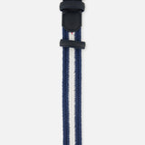 The LA BOUCLE Bristol Chevron Club Belt is a one-size stretch belt with a silver buckle, navy blue edges, a central white stripe bordered by thinner blue stripes, and finished with a leather end and loop. Shown on a white background.