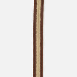The Canterbury Chevron Club Belt by LA BOUCLE is a brown and beige woven stretch belt with a brown leather tip featuring embossed detailing.