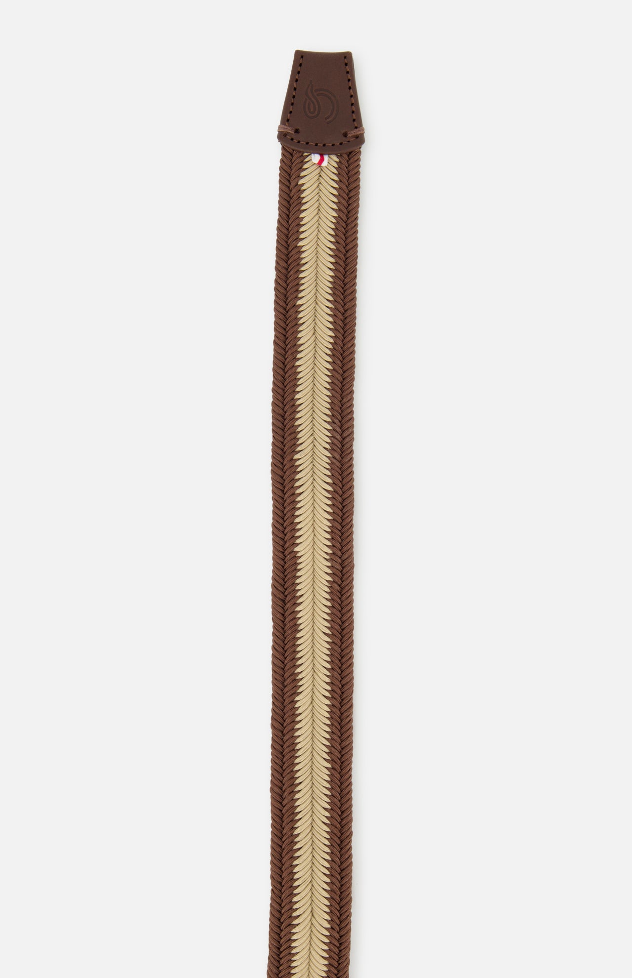 The Canterbury Chevron Club Belt by LA BOUCLE is a brown and beige woven stretch belt with a brown leather tip featuring embossed detailing.