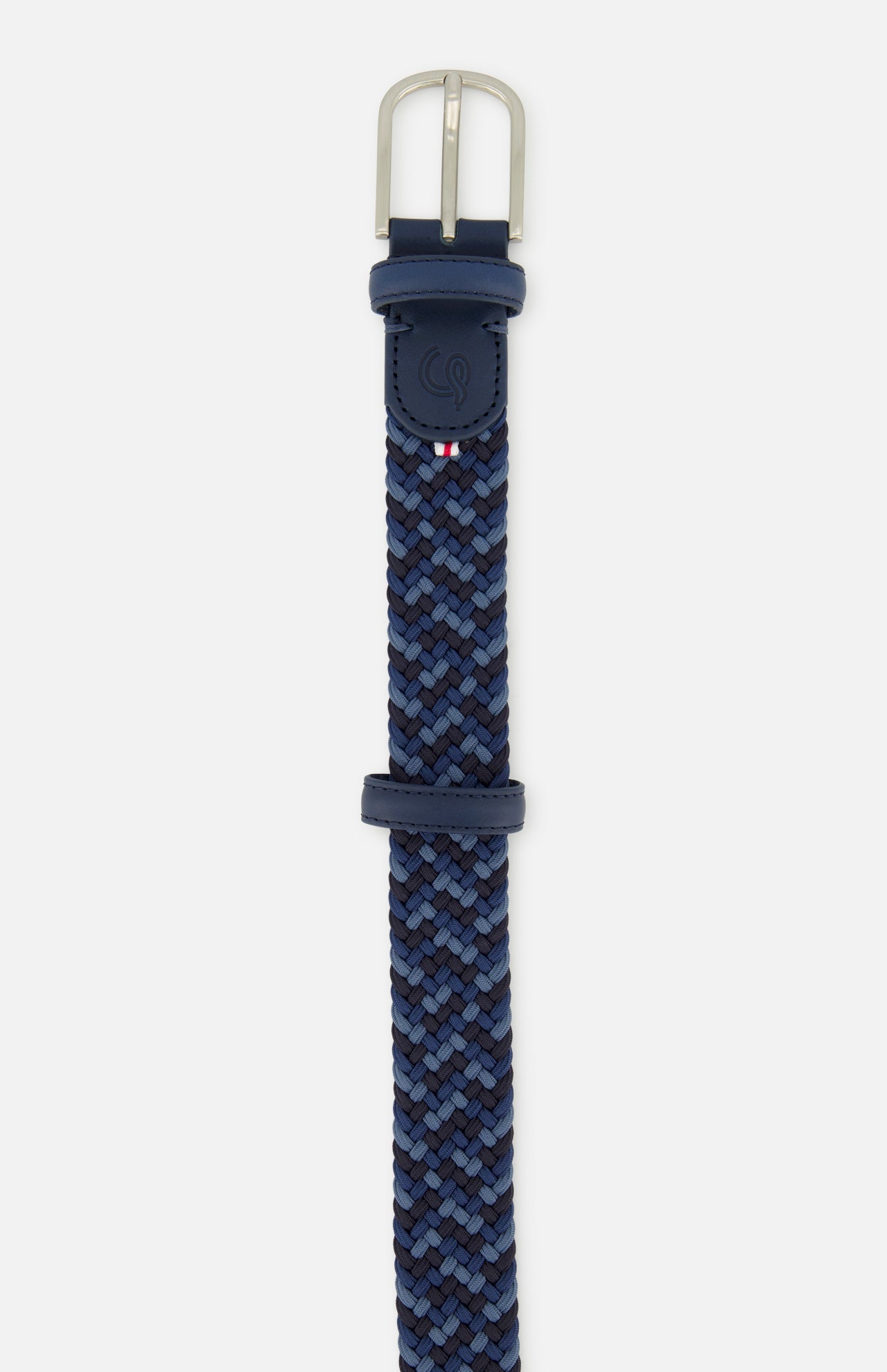 The LA BOUCLE Manhattan Belt is a one-size woven stretch belt in blue shades with leather accents near its silver buckle, a small logo, and a red, white, and blue striped detail—offering comfort and versatile style.