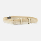 The LA BOUCLE Nice Chevron Sunset Belt features a beige stretch design with a silver rectangular buckle, two loops, and leather accents at the ends, shown on a white background.
