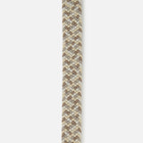 A close-up of the LA BOUCLE Santa Monica Suede belt, featuring a braided woven pattern in beige, brown, and cream with a tan leather tip and visible stitching.