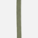 The Veneto Suede Waxed Cotton Belt by LA BOUCLE features an olive green stretch weave with a stitched triangular suede tip and a small red and white tag underneath.