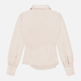 Back view of the L'AGENCE Bernice Satin Wrap Blouse in light beige, showcasing long sleeves, a collar, fitted waist, and buttoned cuffs on a plain white background.