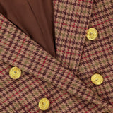 Close-up of the L’AGENCE Bethany Structured Houndstooth Blazer in brown and burgundy plaid, featuring structured shoulders, gold decorative buttons, brown lining, and an inner label that reads “L’AGENCE Est. 2008.”.