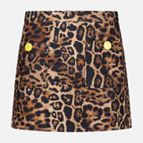 The Cyra Low Rise Mini Skirt by L'AGENCE features a bold leopard print in brown, black, and tan, two front pockets with gold buttons, and a modern twist on classic tweed styles.