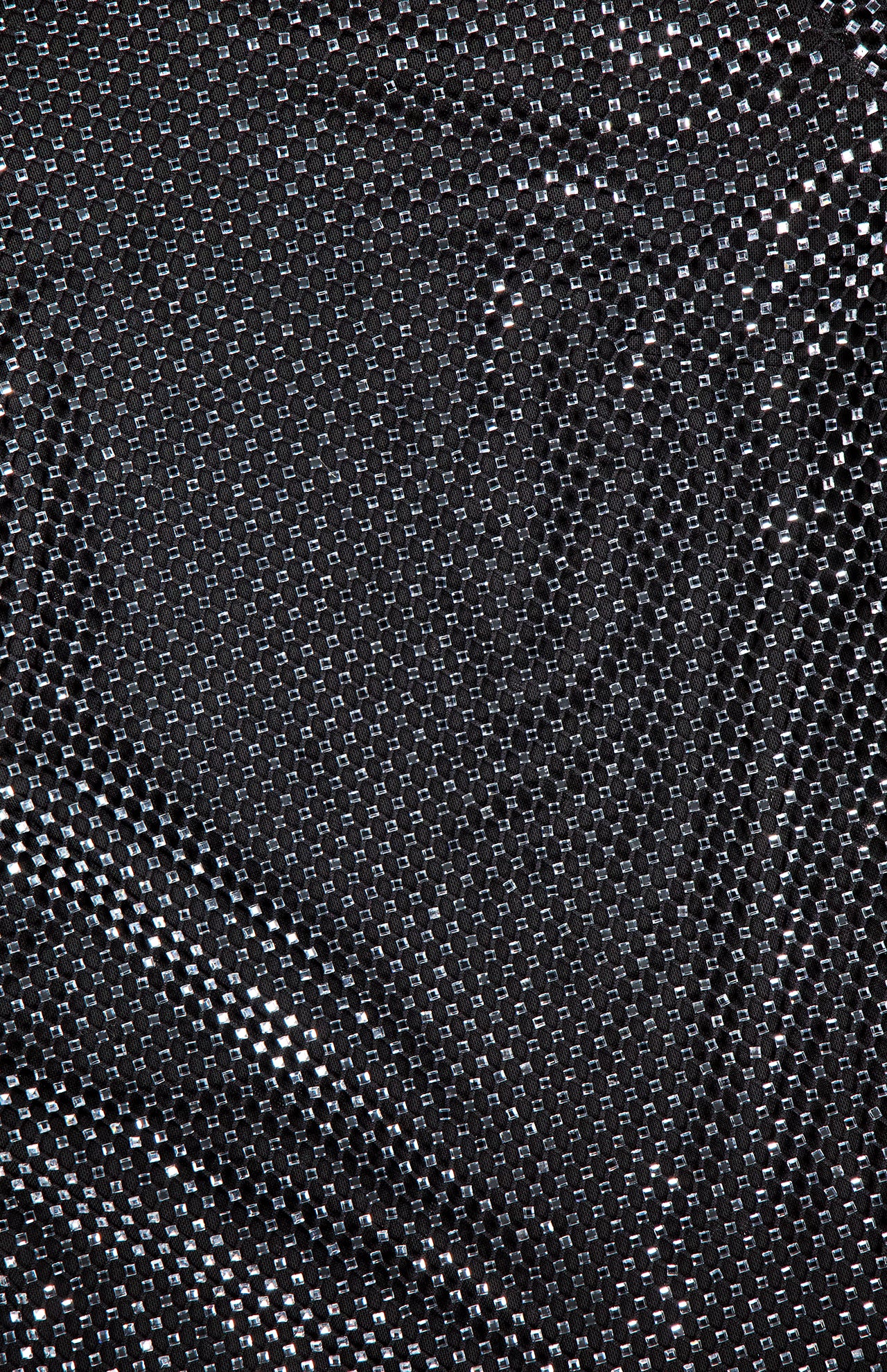 Close-up of the L'AGENCE Harlynn Crystal Mini Dress, featuring shiny black fabric with a grid of reflective silver squares that creates a rhinestone-studded effect—ideal for making a statement at parties or as an eye-catching black mini dress.