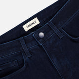 Close-up of the waistband and front pockets of the Marguerite High Rise Skinny Jean by L’Agence, in dark blue stretch denim with a silver button and visible inner brand label, combining comfort and style.