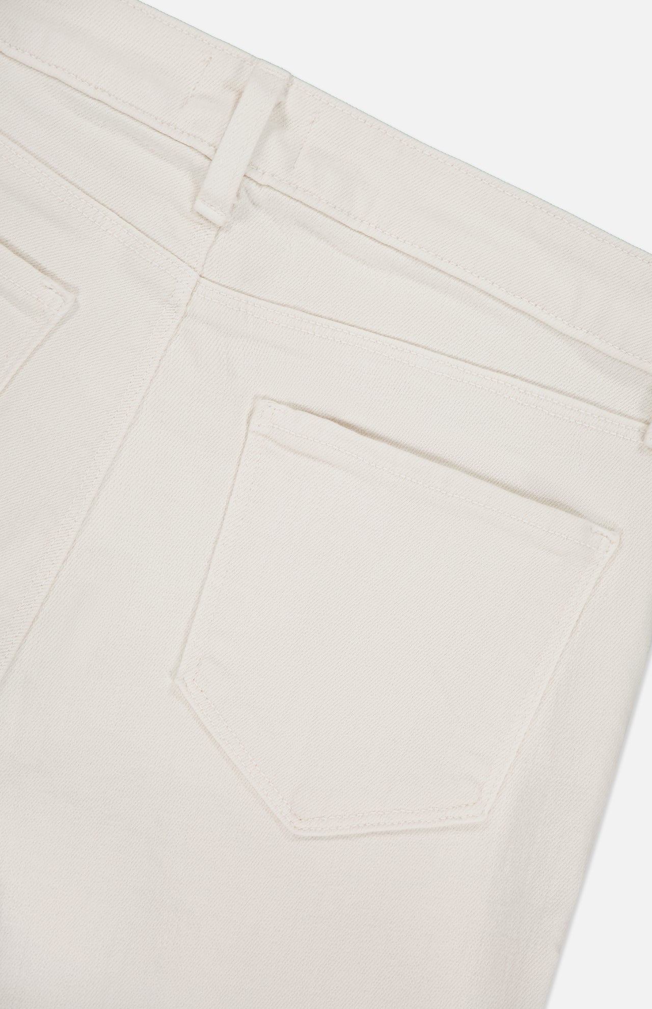 Close-up of the back of L'AGENCE Ruth High Rise Straight Jean in off-white premium stretch denim, highlighting a belt loop, back yoke, and single back pocket against a plain background.