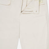 The Ruth High Rise Straight Jean by L’AGENCE is crafted from premium stretch denim in off-white, featuring front pockets, belt loops, and a partially open zipper and button that reveal the branded “L’AGENCE” label on the waistband.