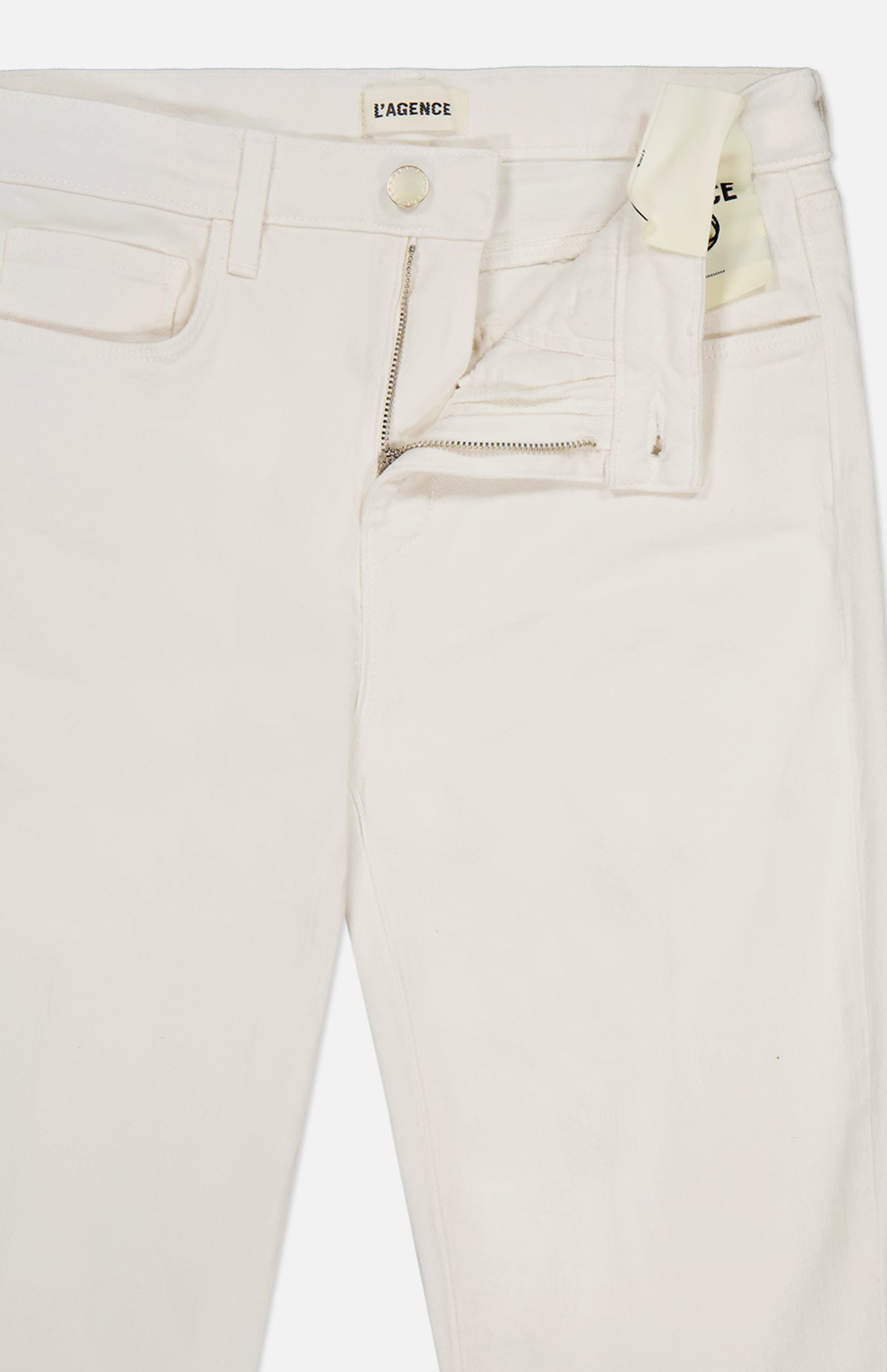 The Ruth High Rise Straight Jean by L’AGENCE is crafted from premium stretch denim in off-white, featuring front pockets, belt loops, and a partially open zipper and button that reveal the branded “L’AGENCE” label on the waistband.