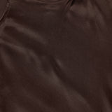 Close-up of the Sayla Bias Cut Maxi Dress by L'AGENCE in smooth, dark brown silk, showcasing the neckline, shoulder seam, and luxurious fabric texture for a touch of vintage glamour.