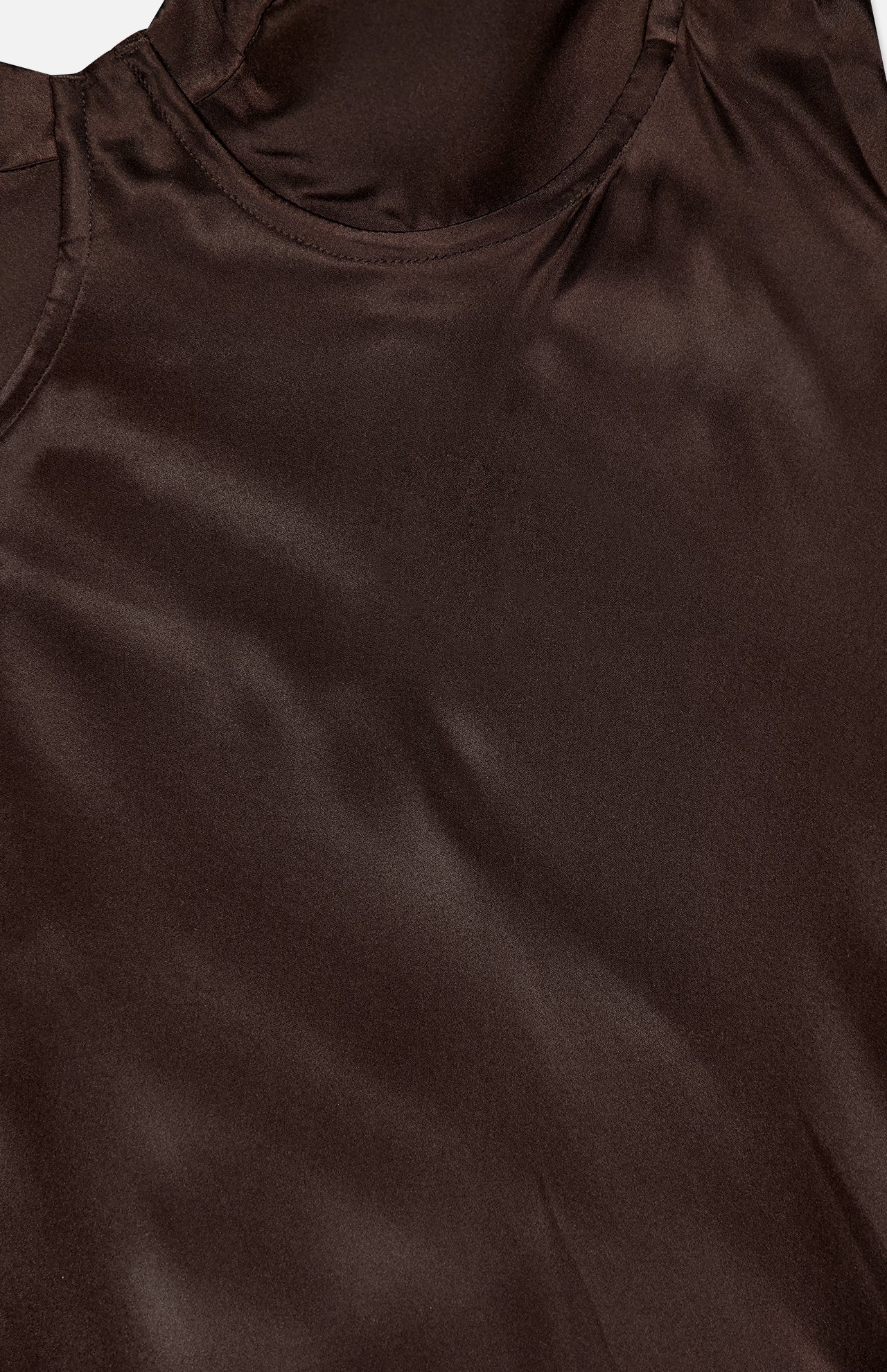 Close-up of the Sayla Bias Cut Maxi Dress by L'AGENCE in smooth, dark brown silk, showcasing the neckline, shoulder seam, and luxurious fabric texture for a touch of vintage glamour.