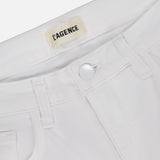Close-up of the waistband and front pocket of Amaris High Rise Skinny Pedal Pusher Pants in white, featuring a silver button and an inner label that reads L'AGENCE.