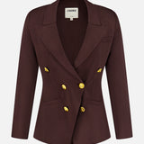 The Amelia Knit Blazer by L’AGENCE is a dark brown, double-breasted blazer with peaked lapels and six shiny gold buttons. This fitted knit design features long sleeves and is shown against a plain white background.