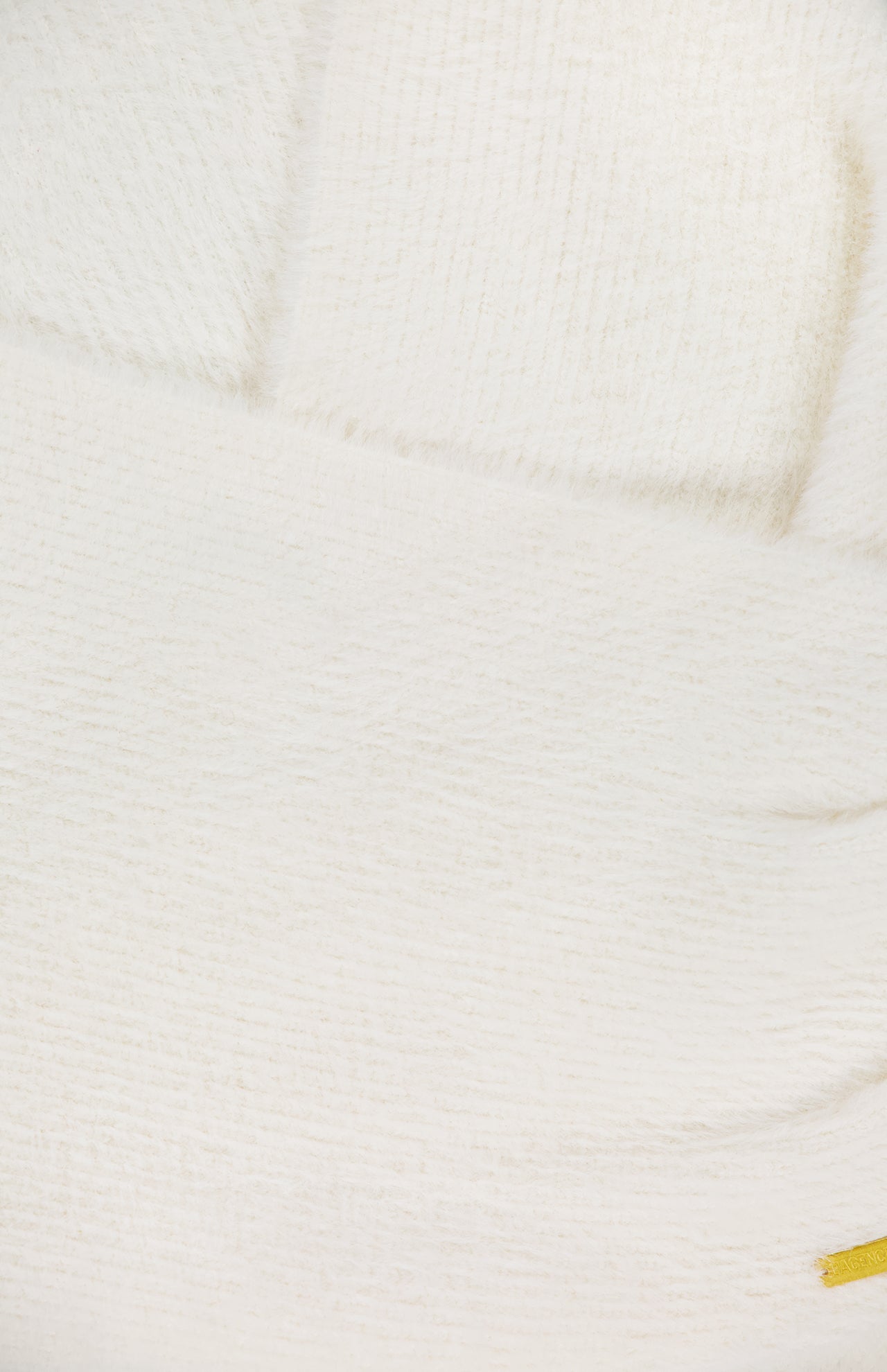 Close-up of the Antonella Surplus Pullover Sweater by L'AGENCE, featuring a soft ivory knit with subtle vertical and horizontal lines. A hint of yellow appears at the bottom right corner.