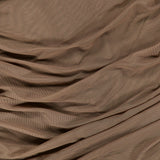 The Anya Shirred Midi Dress by L’AGENCE features a brown, softly wrinkled fabric with gentle folds and creases that create a beautifully textured surface. The lightweight, slightly sheer stretch mesh gives this sleeveless midi dress a delicate and elegant look.