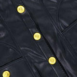 Close-up of the L’AGENCE Apolline Collar Racer Mini Dress in black vegan leather, showcasing detailed stitching, visible seam pockets, and bold shiny gold embossed buttons.