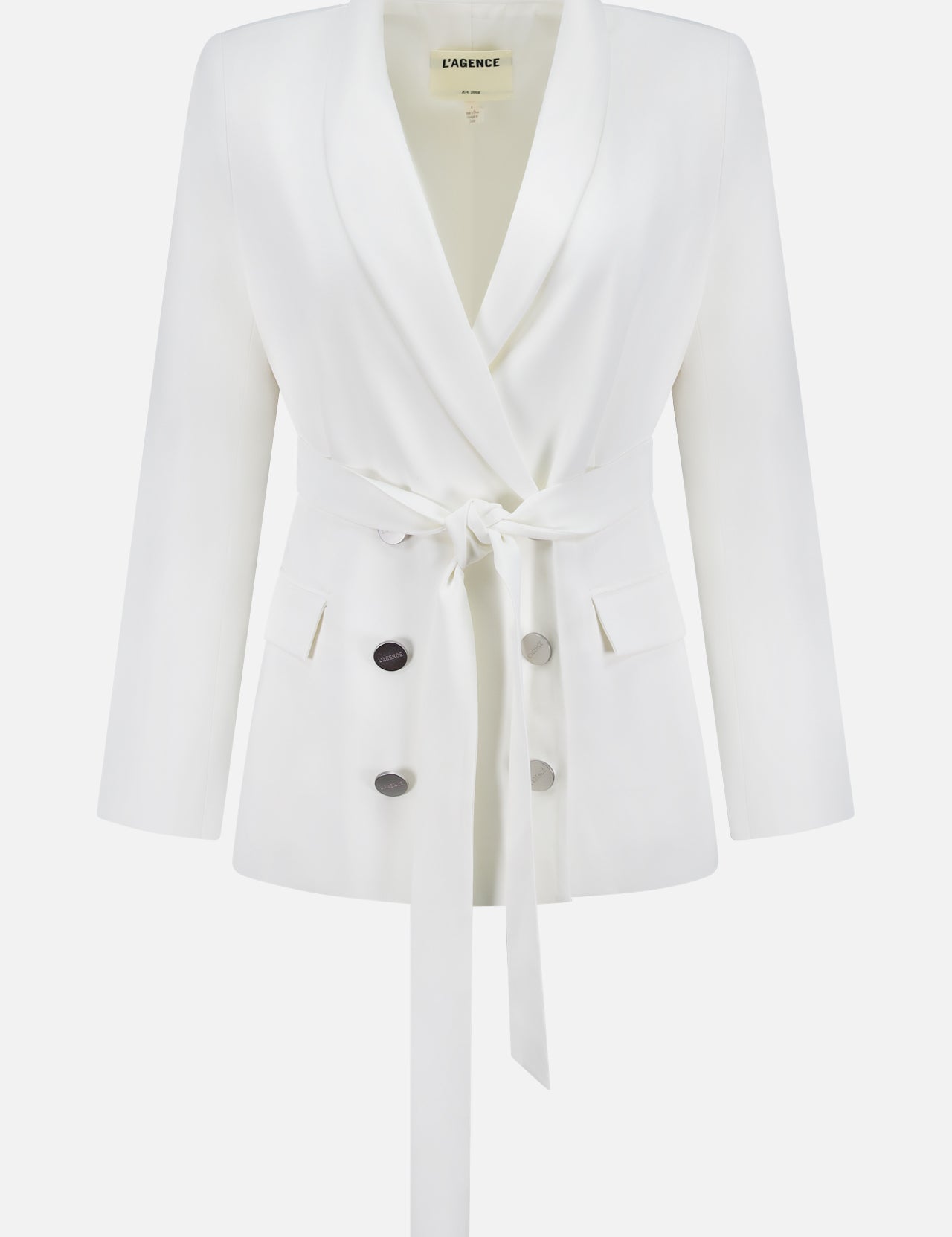 The Aven Belted Wrap Blazer by L'AGENCE is an off-white, double-breasted blazer with a shawl collar, long sleeves, four buttons, two front pockets, and a matching fabric waist tie. The label in the collar reads L'AGENCE.