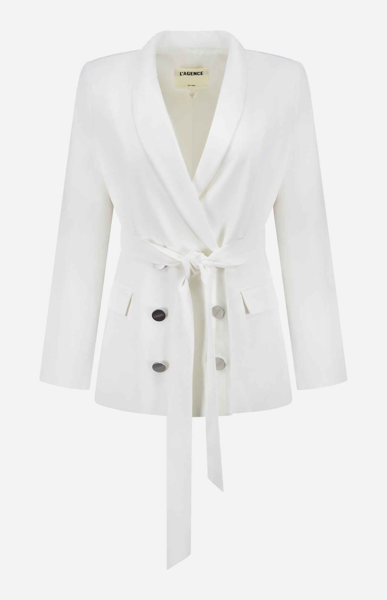 The Aven Belted Wrap Blazer by L'AGENCE is an off-white, double-breasted blazer with a shawl collar, long sleeves, four buttons, two front pockets, and a matching fabric waist tie. The label in the collar reads L'AGENCE.