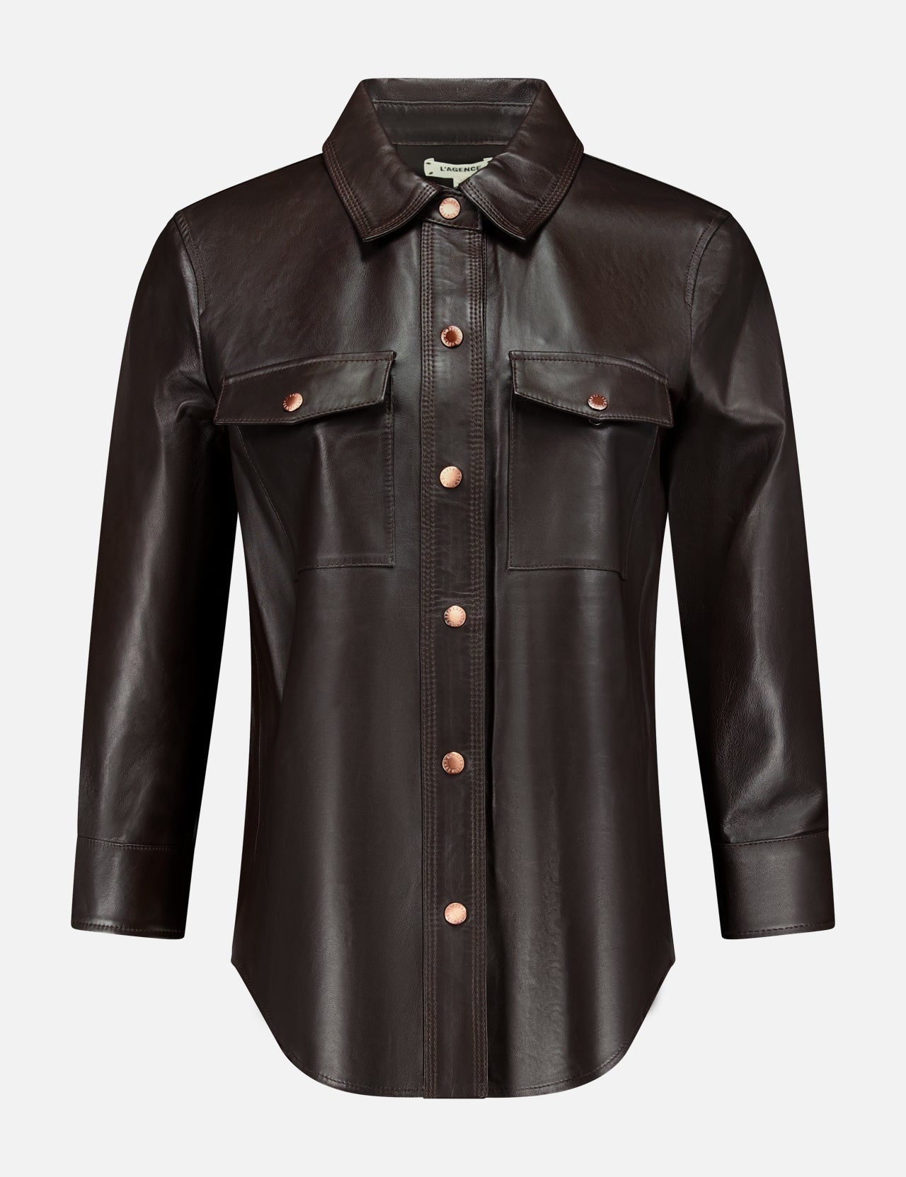 The L’AGENCE Avina Leather 3/4 Sleeve Blouse in dark brown features a pointed collar, front button closure, and two chest pockets with flaps, all showcased on a plain white background. This coffee bean blouse offers timeless style and luxury for an elegant, sophisticated look.