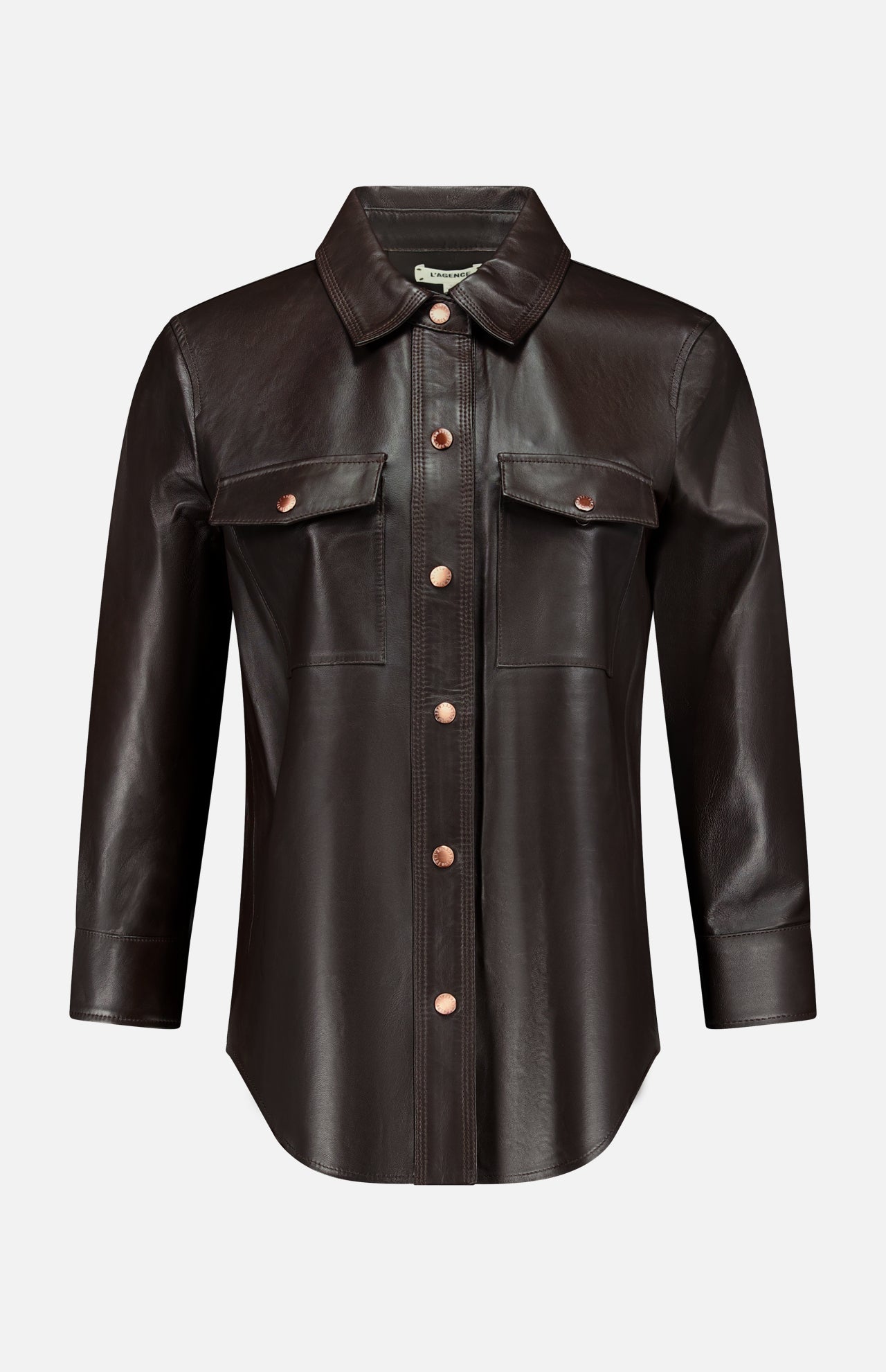 The L’AGENCE Avina Leather 3/4 Sleeve Blouse in dark brown features a pointed collar, front button closure, and two chest pockets with flaps, all showcased on a plain white background. This coffee bean blouse offers timeless style and luxury for an elegant, sophisticated look.
