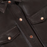 Close-up of the Avina Leather 3/4 Sleeve Blouse by L’AGENCE in dark brown lamb leather, featuring two front pockets, copper-colored buttons, and a visible L’AGENCE label on the collar.