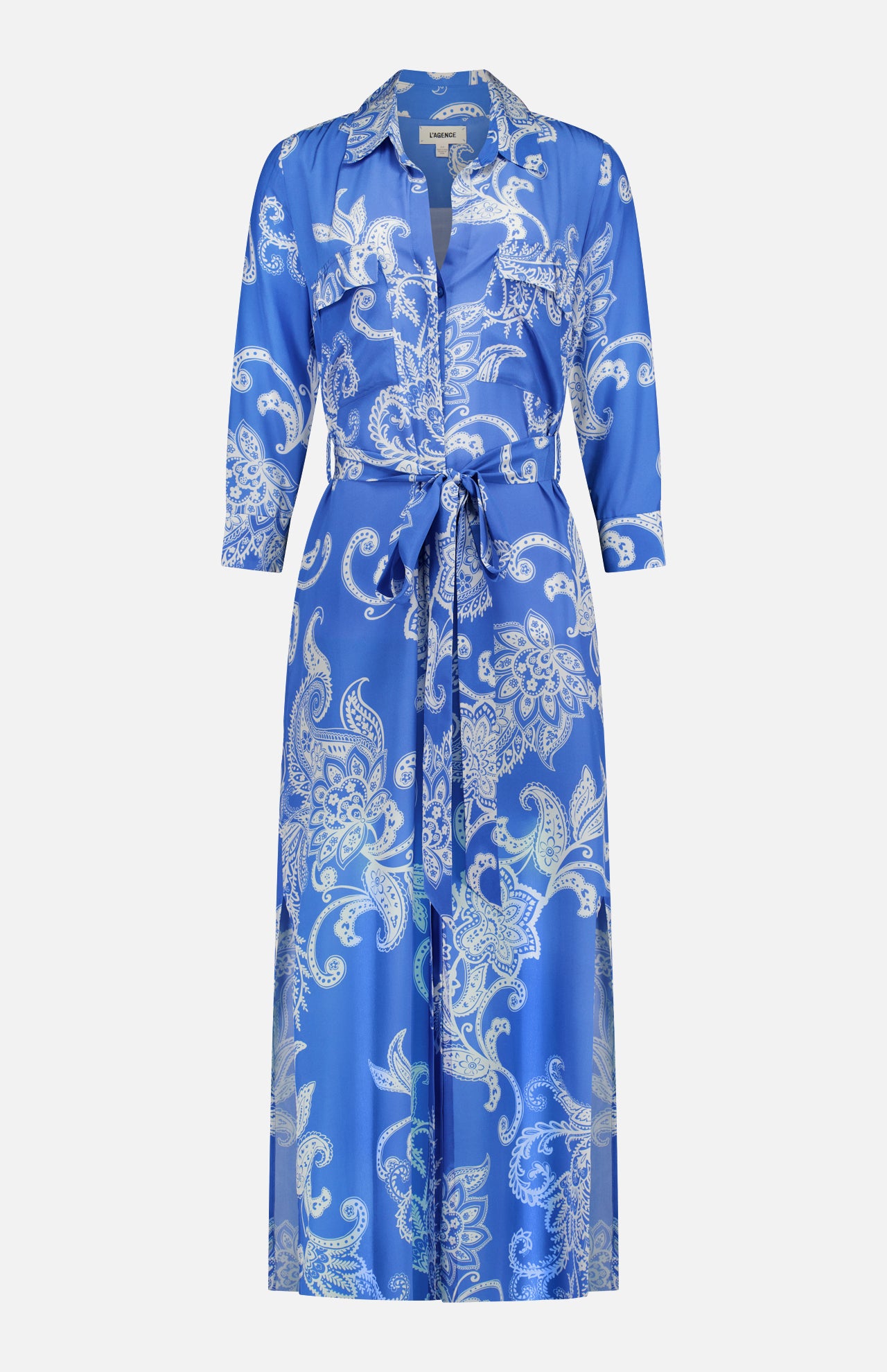 The Cameron Long Silk Shirt Dress by L'AGENCE is a relaxed-fit, floor-length blue and ivory dress with a white paisley print, collared neckline, long sleeves, belted waist, button-down front, and two chest pockets.