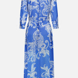 The L'AGENCE Cameron Long Silk Shirt Dress is a floor-length blue and ivory piece with long sleeves, white paisley pattern, belted waist, and straight hem. Shown from the back, this maxi offers an elegant, timeless silhouette.
