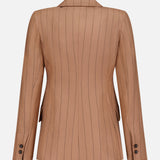 The Chamberlain Pinstripe Blazer by L'AGENCE is showcased from the back, highlighting its tan fabric with black pinstripes, a notch collar, long sleeves, and black buttons on the cuffs. Designed with a tailored fit and two side vents, this women's office blazer is a versatile addition to your professional wardrobe.