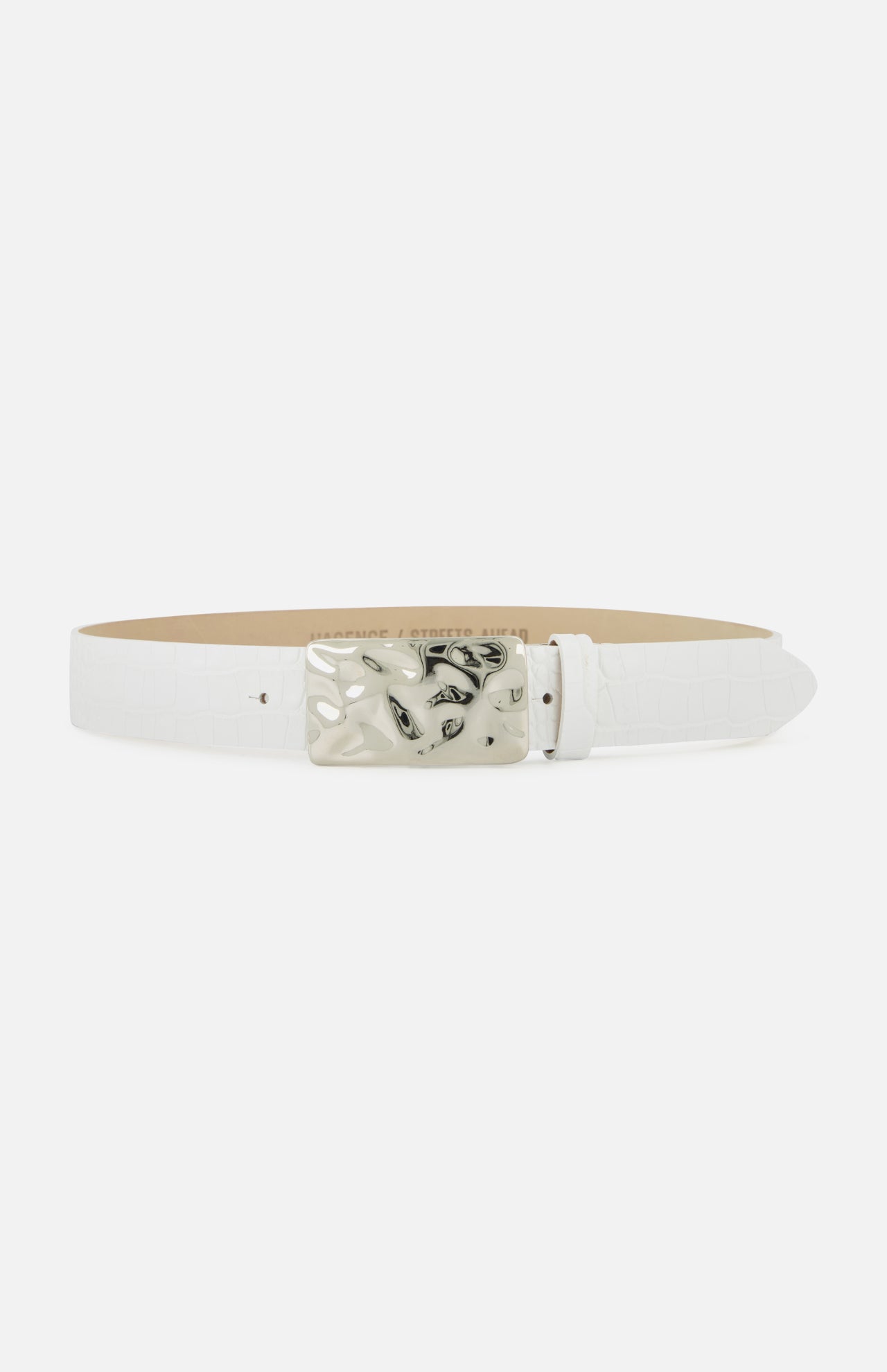 The Chara Organic Hammer Belt by L'AGENCE is a white leather belt with a textured finish and a rectangular marbled silver buckle with black accents, shown against a plain white background.