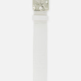 The Chara Organic Hammer Belt by L'AGENCE features white croc-embossed leather and a shiny, wavy silver rectangular buckle. Laid flat on a white background, its textured finish and bold design are highlighted.