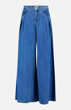 The Chayse High Rise Super Wide Leg Jean in Towson by L’AGENCE features blue denim with front pleats, side pockets, and a button closure at the waist, shown against a white background.