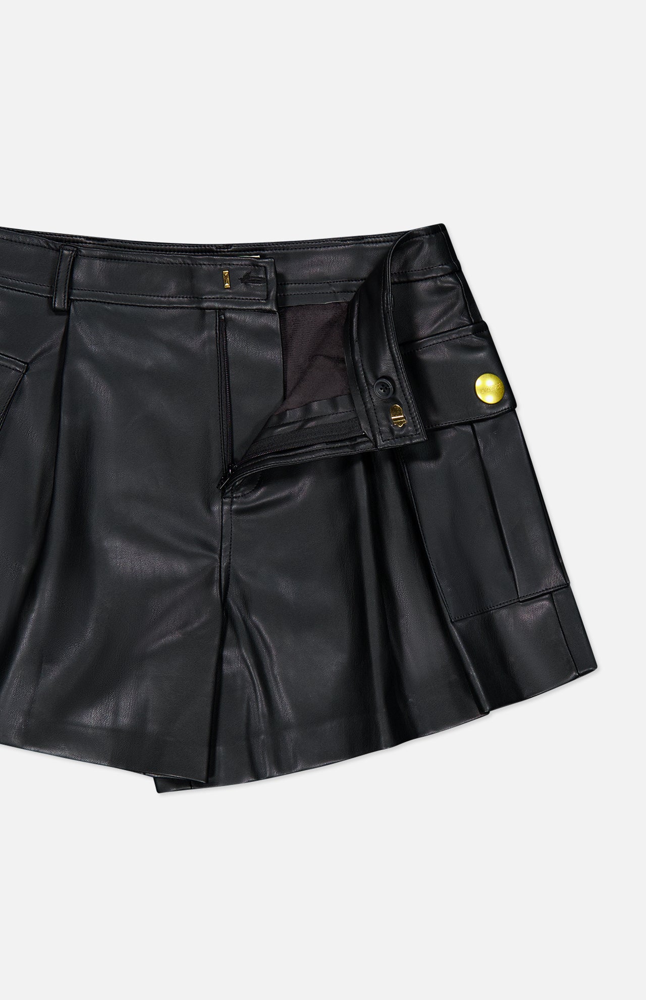 Clairmont Cargo Short in black faux leather featuring a pleated front, a side cargo pocket, and gold-tone button detail.
