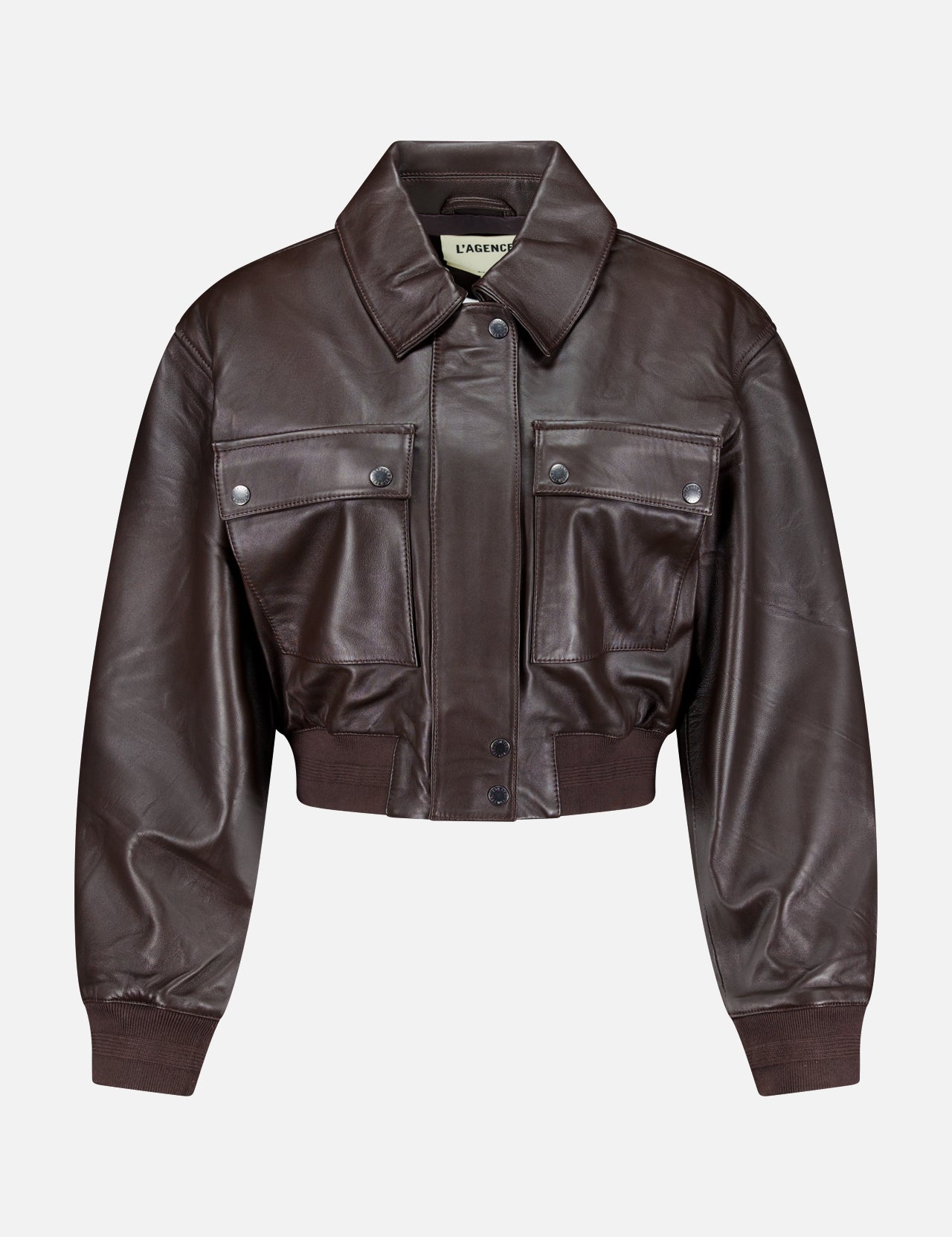 L’AGENCE Clotilde Leather Bomber Jacket in dark brown, featuring a cropped silhouette with a pointed collar, front snap buttons, two large flap chest pockets, and ribbed cuffs and hem, displayed on a plain white background.