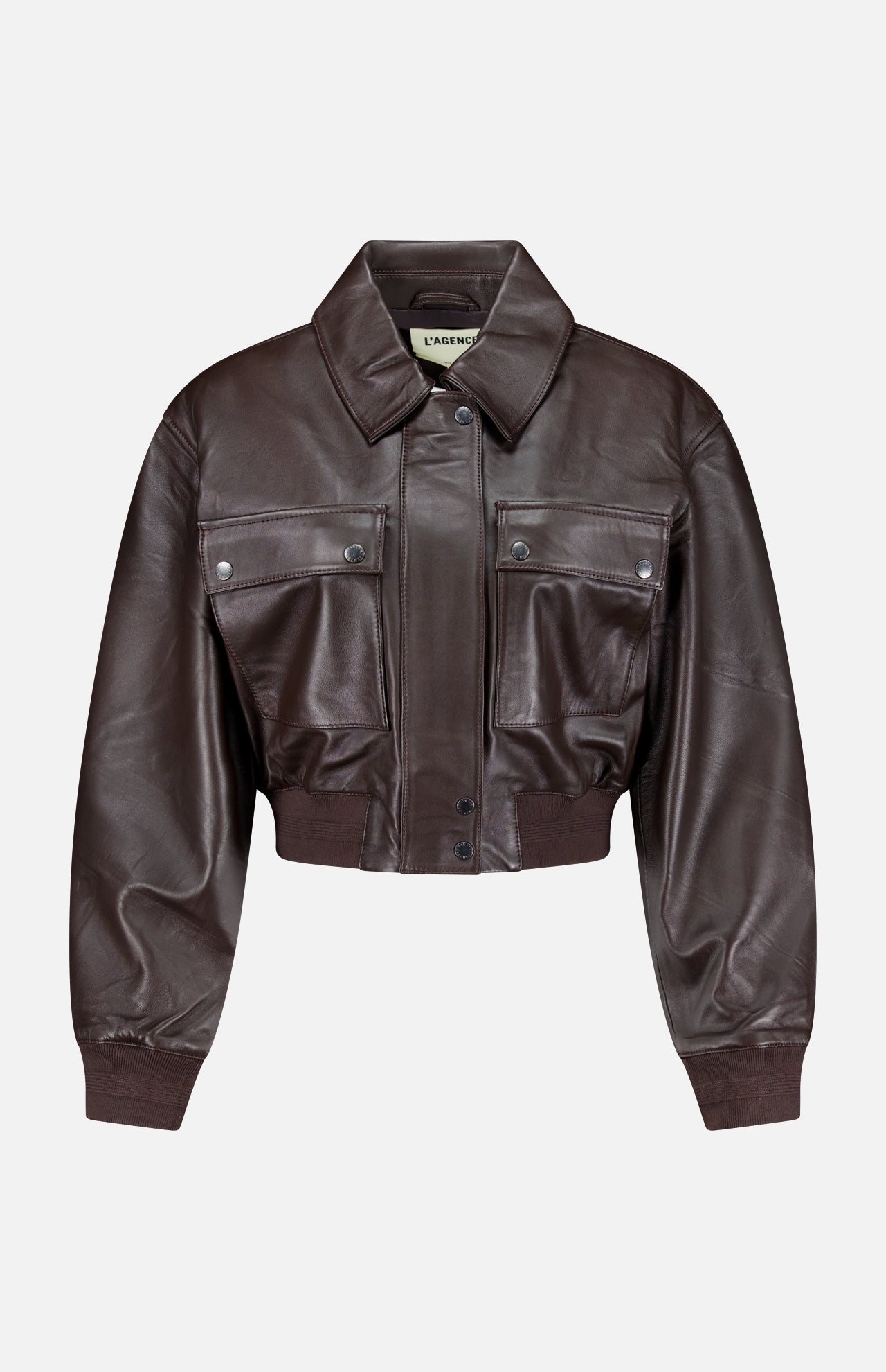 L’AGENCE Clotilde Leather Bomber Jacket in dark brown, featuring a cropped silhouette with a pointed collar, front snap buttons, two large flap chest pockets, and ribbed cuffs and hem, displayed on a plain white background.