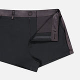 Colt Tux Short in black with a dark satin waistband and side trim, shown partially unzipped.