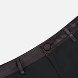 Close-up of the waistband and button closure of L’Agence Colt Tux Short, featuring black tuxedo shorts with a satin-trimmed waist.