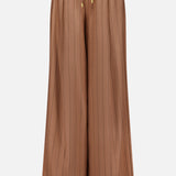 The Connie Drawstring Pinstripe Trouser by L'AGENCE features a wide-leg, high-waisted silhouette in brown with subtle vertical pinstripes, an elastic waistband, and a drawstring finished with gold metal tips. Shown against a plain white background, these trousers are ideal for pairing with the matching blazer to complete your look.