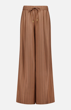 The Connie Drawstring Pinstripe Trouser by L'AGENCE features a wide-leg, high-waisted silhouette in brown with subtle vertical pinstripes, an elastic waistband, and a drawstring finished with gold metal tips. Shown against a plain white background, these trousers are ideal for pairing with the matching blazer to complete your look.